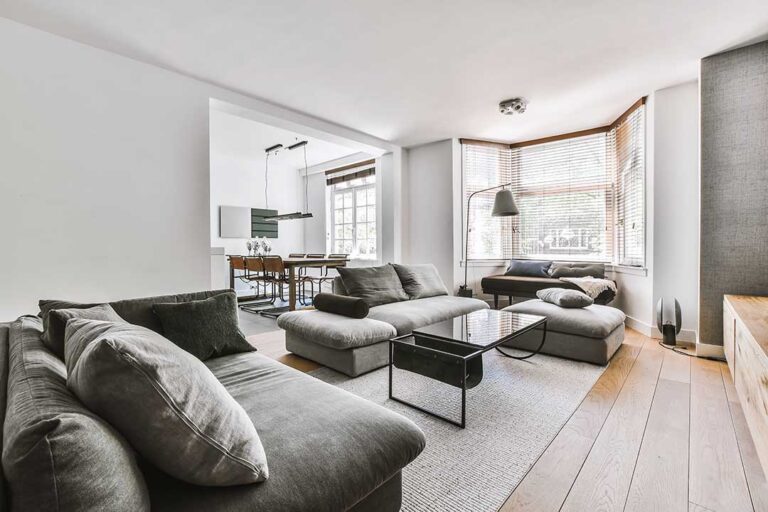 Two adults reviewing a home inspection report inside a cozy, wood-accented living room.